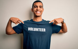 man wearing shirt that says "volunteer"